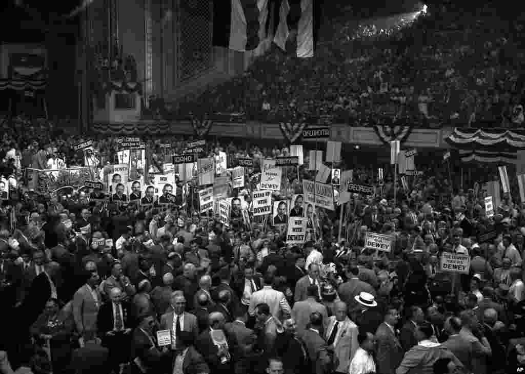 FILE - Delegates with posters and state signs crowd the center aisle in Philadelphia during a demonstration for Gov. Thomas E. Dewey after his name was placed in nomination during the Republican National Convention, June 23, 1948. Dewey and Earl Warren were nominated as presidential and vice presidential candidates, respectively.