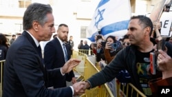 FILE — U.S. Secretary of State Antony Blinken shakes hands with a man as he meets demonstrators calling for the release of hostages kidnapped in the October 7 attack on Israel by Hamas, outside the Kempinski hotel in Tel Aviv, Israel, March 22, 2024.