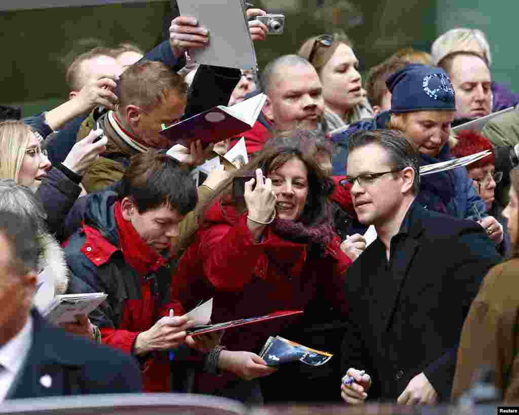 Cast member Matt Damon prepares to sign autographs during the 64th Berlinale International Film Festival in Berlin, Germany.