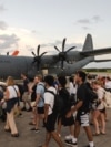 A handout photo taken on Dec. 21, 2024 and received from the Australian Department Foreign Affairs and Trade shows Australian Defense Forces helping Australians off a C-130J Hercules at Brisbane Airport after an earthquake struck Port Vila, Vanuatu. 