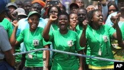 FILE: Supporters of Zimbabwean President Emmerson Mnangagwa chant his name as he inspects the guard of honour during the opening session of parliament in Harare, Tuesday, Oct, 1, 2019. 