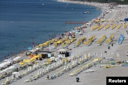 Tourists enjoy a beach in the Mediterranean resort city of Antalya, a popular destination for German tourists, in Turkey, July 25, 2016.