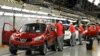 FILE - A worker is seen completing final checks on the production line at Nissan car plant in Sunderland, northern England, June 24, 2010. 