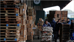 Eduardo David Rodriguez, 40, pushes a cart with bags of potatoes at the Mercado Central where he works twice a week earning 12,000 Argentine Pesos ($60) a month, in Buenos Aires, Argentina September 28, 2021.