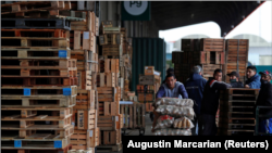 Eduardo David Rodriguez, 40, pushes a cart with bags of potatoes at the Mercado Central where he works twice a week earning 12,000 Argentine Pesos ($60) a month, in Buenos Aires, Argentina September 28, 2021.