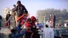 FILE - Rohingya refugees board a naval ship to be transported to an isolated island in the Bay of Bengal, in Chittagong, Bangladesh, Dec. 29, 2020.