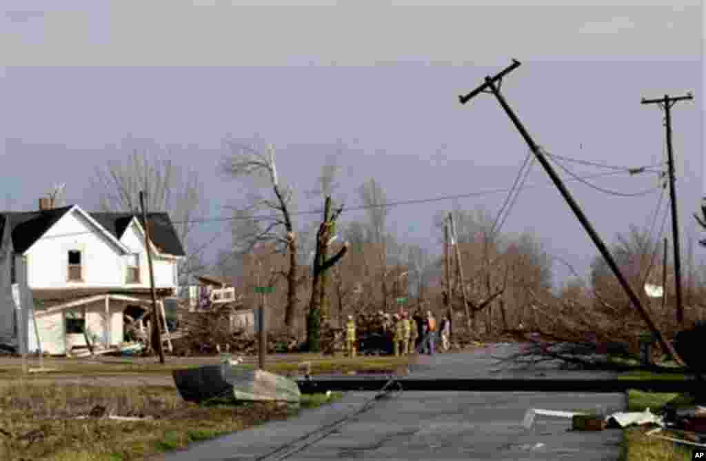 Residents of Marysville, Ind., survey the tornado damage to their homes Friday, March 2, 2012 in Marysville, Ind. Powerful storms stretching from the U.S. Gulf Coast to the Great Lakes in the north wrecked two small towns, killed at least three people and