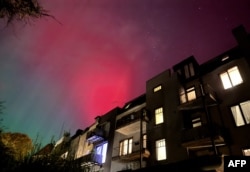 The northern lights are seen over a building close to Kiel, northern Germany, Oct. 10, 2024.