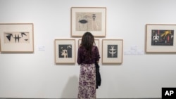 FILE—A visitor observes artwork by Afro-Cuban painter Wifredo Lam at the Mohammed VI Museum of Modern and Contemporary Art in Rabat, April 1, 2024.