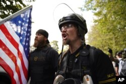 Members of the Proud Boys and other right-wing demonstrators rally, Sept. 26, 2020, in Portland, Ore.