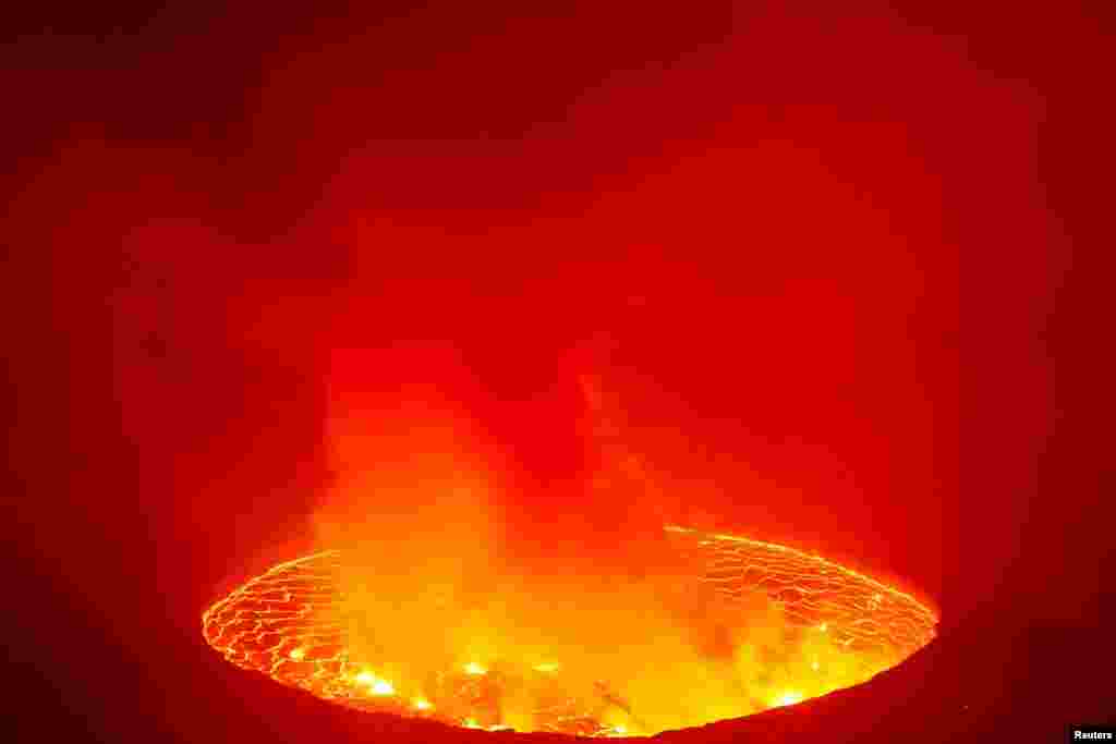 A lava lake illuminates the night sky above the Mount Nyiragongo volcano, inside the Virunga National Park, near Goma, in the eastern Democratic Republic of Congo, in this image taken on Feb. 11, 2021.