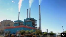 FILE - Smoke rises from the Colstrip Steam Electric Station, a coal-burning power plant in Colstrip, Mont., July 1, 2013. The Trump administration is advancing its plan to replace the centerpiece of President Barack Obama's efforts against global warming with a new rule expected to be more friendly to the coal industry.