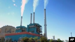 FILE - Smoke rises from the Colstrip Steam Electric Station, a coal-burning power plant in Colstrip, Mont., July 1, 2013. 