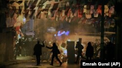 Demonstrators clash with riot police following the funeral of Berkin Elvan, who had been in a coma after a police tear-gas canister struck him in the head last year, in Istanbul, March 12, 2014. 