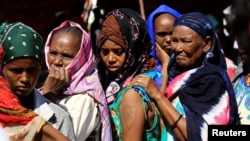 Ethiopian refugees who fled Tigray region, queue to receives treatment within the Fashaga camp on the Sudan-Ethiopia border, in Kassala state, Sudan, Dec. 14, 2020.