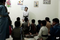 Boys recite poems during a session at a rehabilitation center for former child soldiers in Marib, Yemen, in this July 25, 2018, photo. (AP Photo/Nariman El-Mofty)