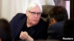 FILE - U.N. envoy to Yemen Martin Griffiths listens to the undersecretary of Houthi-led government's foreign ministry, Faisal Amin Abu-Rass upon his arrival at Sanaa airport in Sanaa, Yemen, June 16, 2018.