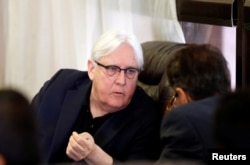 FILE - U.N. envoy to Yemen Martin Griffiths listens to the undersecretary of Houthi-led government's foreign ministry, Faisal Amin Abu-Rass upon his arrival at Sana'a airport in Sana'a, Yemen, June 16, 2018.