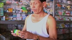 A Cambodian man purchases malaria medicine