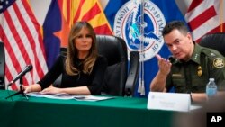 First lady Melania Trump talks with Rodolfo Karisch, Chief Patrol Agent, Tucson Sector Border Patrol, as she visits a U.S. Customs border and protection facility in Tucson, Arizona, June 28, 2018. 