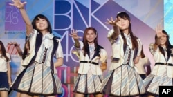 FILE - Thai pop band BNK 48 performs for the first time in a large commercial facility in Bangkok, Thailand, June 2, 2017. 