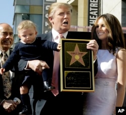 Donald Trump, the billionaire developer, and producer of NBC's "The Apprentice," with his wife, Melania Knauss, and their son, Barron, pose for a photo after he was honored with a star on the Hollywood Walk of Fame in Los Angeles, Tuesday, Jan. 16, 2007.