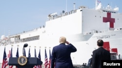 U.S. President Donald Trump salutes the crew of the Navy hospital ship USNS Comfort at Naval Station Norfolk, in Norfolk, Virginia, U.S. March 28, 2020.