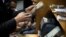 FILE - Egyptians count money at a currency exchange office in downtown Cairo, Jan. 2, 2013. 