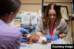 In this 2018 photo, nurses care for a micro preemie at Children's National NICU in Washington, D.C.