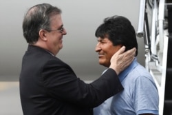 Bolivia's ousted President Evo Morales is welcomed by Mexico's Foreign Minister Marcelo Ebrard during his arrival to take asylum in Mexico, in Mexico City, Mexico, Nov. 12, 2019.