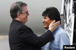 Bolivia's ousted President Evo Morales is welcomed by Mexico's Foreign Minister Marcelo Ebrard during his arrival to take asylum in Mexico, in Mexico City, Mexico, Nov. 12, 2019.
