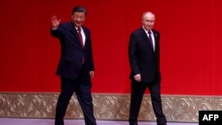 (FILE) A photograph distributed by the Russian state agency Sputnik, Russia's President Vladimir Putin and China's President Xi Jinping in Beijing on May 16, 2024.