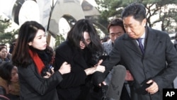 FILE - Cho Hyun-ah, center, former vice president of Korean Air Lines, arrives at the Seoul Western District Prosecutors Office in Seoul, South Korea, Tuesday, Dec. 30, 2014.