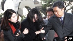 Cho Hyun-ah, center, former vice president of Korean Air Lines, arrives at the Seoul Western District Prosecutors Office in Seoul, South Korea, Dec. 30, 2014.