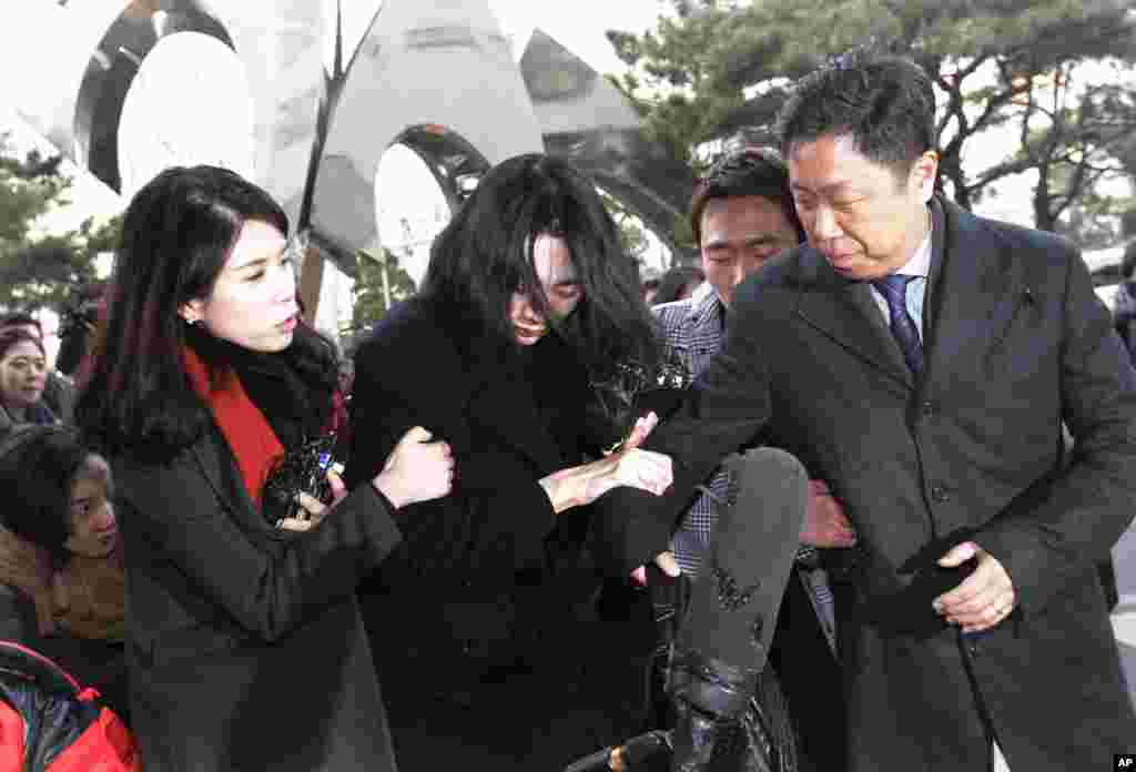 Cho Hyun-ah, center, former vice president of Korean Air Lines, arrives at the Seoul Western District Prosecutors Office in Seoul, South Korea. Cho resigned as vice president of the airline earlier this month amid mounting public criticism over the incident that she forced a flight to return over a bag of macadamia nuts.