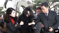 Cho Hyun-ah, center, former vice president of Korean Air Lines, arrives at the Seoul Western District Prosecutors Office in Seoul, South Korea, Dec. 30, 2014.