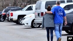 Family members escort their children out of Marshal North Middle School near Palma, Ky., Jan. 23, 2018. The students were taken there from Marshal High School after a shooting there.