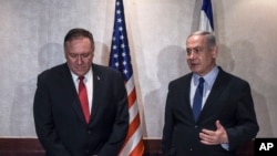 Israeli Prime Minister Benjamin Netanyahu, right, and U.S. Secretary of State Mike Pompeo speak during their meeting in Lisbon, Dec. 4, 2019.