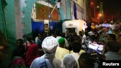 FILE - Supporters gather outside the National Prison during the release of politicians and journalists, after demonstrations in Khartoum, Sudan, Feb. 18, 2018.