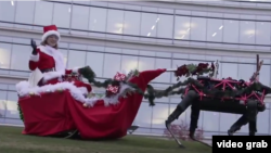 Robotic reindeer pull a Christmas sleigh in this screenshot from a Boston Dynamics video.