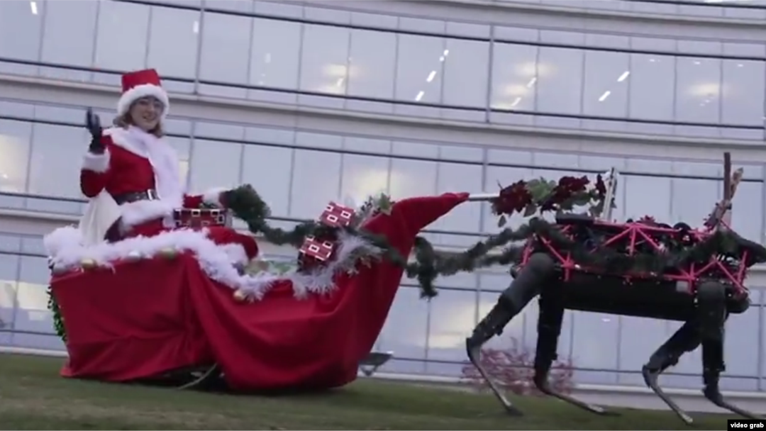 Robotic reindeer pull a Christmas sleigh in this screenshot from a Boston Dynamics video.