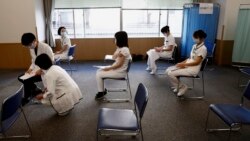 In this Feb. 17, 2021, file photo, medical workers wait for consultation after receiving a dose of the COVID-19 vaccine at Tokyo Medical Center in Tokyo. (Behrouz Mehri/Pool Photo via AP, File)