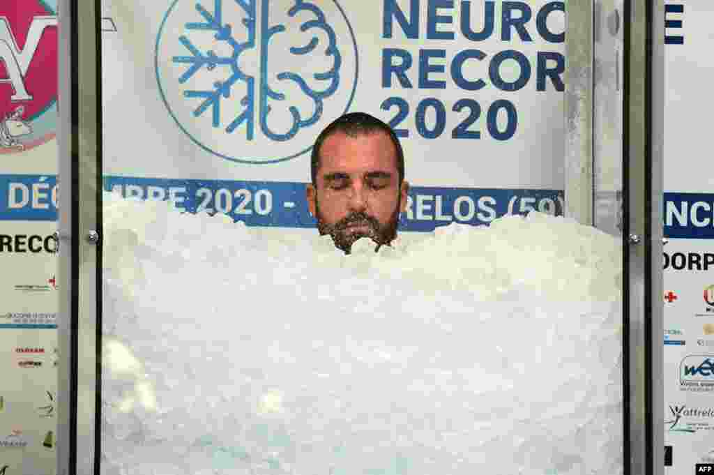 Romain Vandendorpe tries to break the world record for the longest full body contact with ice cubes, in Wattrelos, northern France, Dec. 19, 2020.