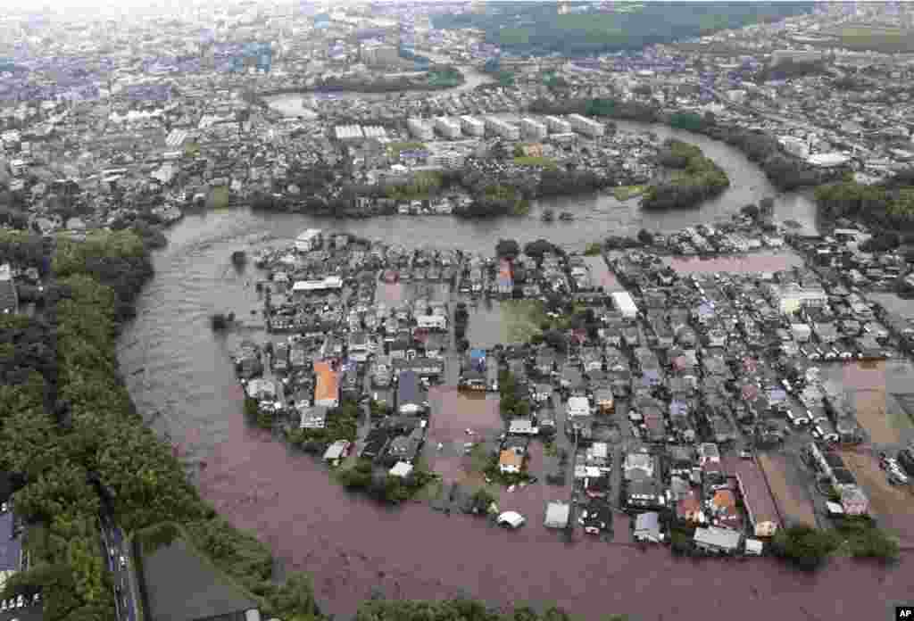 Residential streets are submerged after a river overflowed its banks in Kumamoto, Kumamoto prefecture on Japan&#39;s southern island of Kyushu.