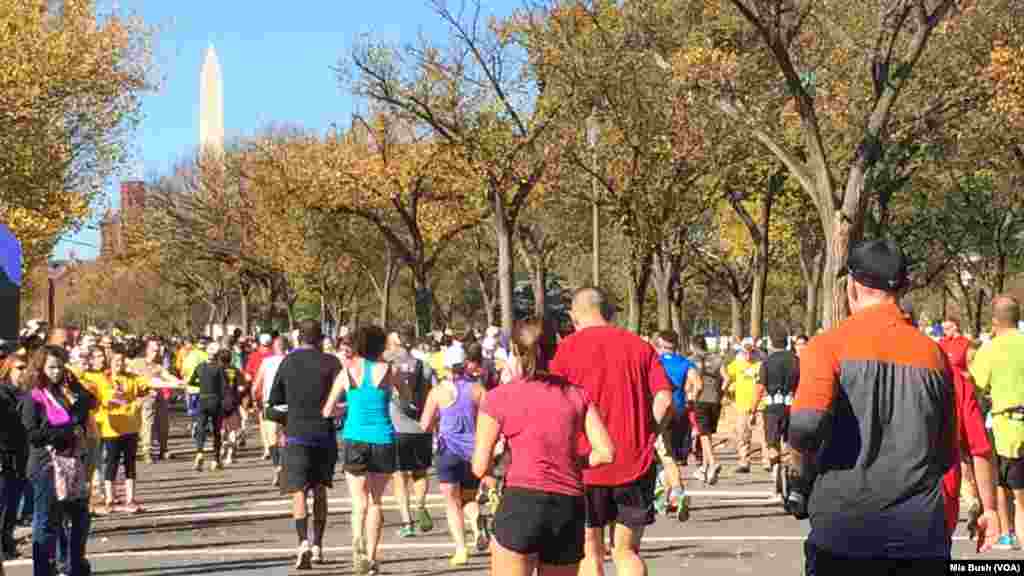 Runners head west on Independence Avenue in Washington Sunday as they near the 19-mile mark of the Marine Corps Marathon. The Washington Monument can be seen in the distance.