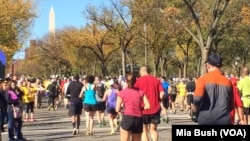 FILE - Runners head west on Independence Avenue in Washington as they near the 19-mile mark of the Marine Corps Marathon in October 2014. The Washington Monument can be seen in the distance.