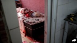 Blood covers the floor and a bed inside a home during a police operation targeting drug traffickers in the Jacarezinho favela of Rio de Janeiro, Brazil, May 6, 2021. Officials said at least 25 people died, including one police officer and 24 suspects.