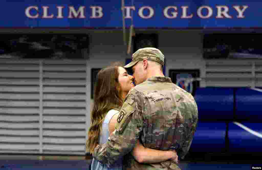 Cpl Preston Dyce, a soldier with the 4th Battalion, 31st Infantry Regiment, 2nd Brigade Combat Team of the 10th Mountain Division, is greeted by his wife Michaela Dyce upon his return home from deployment in Afghanistan, at Fort Drum, New York, Sept. 7, 2021.