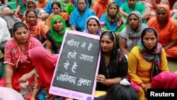 Family members of sanitation workers attend a protest against the rising deaths of people cleaning sewers, in New Delhi, India, Sept. 25, 2018.