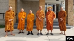 Phra Bhodhinandhamunee (3rd from R)a senior monk and abbot of Wat Pa (Forest) Buddhagayaother, in India and monks from a handful of different US states pose for a photo before to start the walk beside with Phra Sutham Nateetong (4th from R) in Chicago are